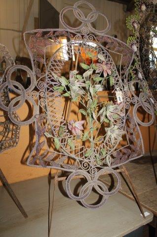 An oval beaded floral display on tripod stand